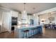 Modern kitchen with stainless appliances, an island with bar stools, and a view of the dining room at 2760 Rustic Lake Ter, Cumming, GA 30041