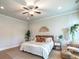 Inviting bedroom featuring natural light, ceiling fan, and hardwood floors at 2760 Rustic Lake Ter, Cumming, GA 30041