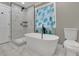 Modern bathroom with soaking tub, walk-in shower, and tile flooring at 4913 Windsor Downs Dr, Decatur, GA 30035