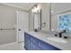 Bathroom with double vanity, blue cabinets, and granite countertop at 4913 Windsor Downs Dr, Decatur, GA 30035