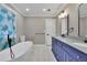 Modern bathroom with double vanity, freestanding tub, and tile floor at 4913 Windsor Downs Dr, Decatur, GA 30035