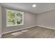 Bright bedroom with large window and wood-look flooring at 4913 Windsor Downs Dr, Decatur, GA 30035