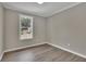 Simple bedroom with gray walls and wood flooring at 4913 Windsor Downs Dr, Decatur, GA 30035