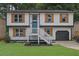 Two-story house with white siding, orange shutters, and a gray door at 4913 Windsor Downs Dr, Decatur, GA 30035