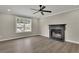 Bright living room with fireplace, large window, and wood-look floors at 4913 Windsor Downs Dr, Decatur, GA 30035