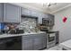 Gray kitchen with stainless steel appliances and tile backsplash at 5031 Woodridge Way, Tucker, GA 30084