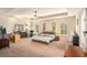 Large main bedroom with carpeted floors and ceiling fan at 100 Canyons Ct, Hampton, GA 30228