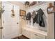 Whitewashed built-in bench with cubbies and coat hooks at 100 Canyons Ct, Hampton, GA 30228