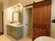 Bathroom with a barn door and modern vanity at 1814 Tristan Se Dr, Smyrna, GA 30080