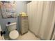 Simple bathroom with toilet, shower, and a dresser for storage at 1814 Tristan Se Dr, Smyrna, GA 30080