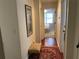 Well-lit hallway showcasing hardwood floors and a red rug at 1814 Tristan Se Dr, Smyrna, GA 30080