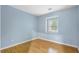 Light and airy bedroom with wood flooring and a window at 729 Cedar Pointe Sw Ct, Marietta, GA 30008