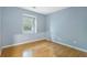 Simple bedroom with light blue walls and wood flooring at 729 Cedar Pointe Sw Ct, Marietta, GA 30008