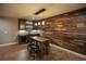 Basement bar with rustic wood wall and pendant lighting at 2455 Ellijay Ne Dr, Brookhaven, GA 30319