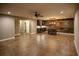 Finished basement with stained concrete floor, wet bar, and rustic wall at 2455 Ellijay Ne Dr, Brookhaven, GA 30319