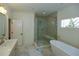 Bathroom with soaking tub, walk-in shower, and marble floor at 2455 Ellijay Ne Dr, Brookhaven, GA 30319