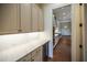 Butlers pantry with marble countertops and wine cooler at 2455 Ellijay Ne Dr, Brookhaven, GA 30319