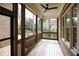 Relaxing screened porch with wood flooring and ceiling fan at 2455 Ellijay Ne Dr, Brookhaven, GA 30319