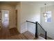 Upstairs hallway with hardwood floors and black railing at 2455 Ellijay Ne Dr, Brookhaven, GA 30319