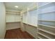 Spacious walk-in closet with custom shelving and hanging rods at 2455 Ellijay Ne Dr, Brookhaven, GA 30319