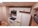 White kitchen with stainless steel appliances and a view into dining area at 2850 Rhett Butler Dr, Douglasville, GA 30135