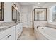 Bright bathroom with a soaking tub, tiled shower, double sink vanity, and neutral color palette at 337 Ellis Preserve Sw Ln, Marietta, GA 30064