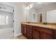 Bathroom with granite counters, double sinks, and wood cabinets at 337 Ellis Preserve Sw Ln, Marietta, GA 30064