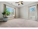 Bedroom featuring neutral colored walls and carpeting, with two windows and curtains at 337 Ellis Preserve Sw Ln, Marietta, GA 30064