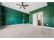 Bedroom featuring hunter green walls, neutral carpeting, and an open doorway to the bathroom at 337 Ellis Preserve Sw Ln, Marietta, GA 30064