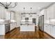 Bright kitchen features white cabinetry, stainless steel appliances, granite countertops and large island at 337 Ellis Preserve Sw Ln, Marietta, GA 30064