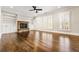 Bright living room with hardwood floors, stone fireplace, and built-in shelving at 337 Ellis Preserve Sw Ln, Marietta, GA 30064