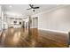 Open-concept living room with hardwood floors and modern lighting fixture overlooking the kitchen and staircase at 337 Ellis Preserve Sw Ln, Marietta, GA 30064