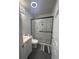 A well-lit bathroom showcasing a shower with glass doors, contemporary fixtures, and neutral color scheme at 6625 Starling Sw Pl, Mableton, GA 30126