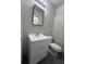Bathroom featuring a contemporary vanity, mirror, toilet, and dark tile flooring, offering a modern, clean look at 6625 Starling Sw Pl, Mableton, GA 30126