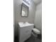 Compact bathroom featuring a functional vanity, square mirror and toilet at 6625 Starling Sw Pl, Mableton, GA 30126