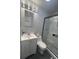 Modern bathroom featuring a glass-door shower, white marble-style tile and a bright vanity sink at 6625 Starling Sw Pl, Mableton, GA 30126