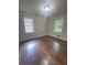 Bright bedroom with hardwood floors, windows, and neutral walls at 6625 Starling Sw Pl, Mableton, GA 30126