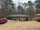 Brick ranch house with a gray roof, nestled on a lot with mature trees at 6625 Starling Sw Pl, Mableton, GA 30126