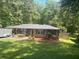 Charming single-story home with a well-manicured lawn and a lush, green treeline in the background at 6625 Starling Sw Pl, Mableton, GA 30126