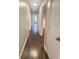 Hallway with hardwood floors leading to various rooms at 6625 Starling Sw Pl, Mableton, GA 30126
