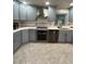 This kitchen features updated stainless appliances, custom blue cabinets, and gorgeous countertops at 6625 Starling Sw Pl, Mableton, GA 30126