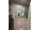 This laundry room is complete with a modern washer and dryer set and a door leading to the outside at 6625 Starling Sw Pl, Mableton, GA 30126