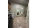 Practical laundry room featuring tile floors, a washer and dryer and convenient access to the backyard at 6625 Starling Sw Pl, Mableton, GA 30126