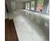Large living room with expansive flooring and large windows to allow ample light at 6625 Starling Sw Pl, Mableton, GA 30126