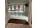 Bright living room with large windows, a ceiling fan, and updated flooring at 6625 Starling Sw Pl, Mableton, GA 30126