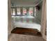 Spacious living area with hardwood floors, large windows, and access to the outdoor deck at 6625 Starling Sw Pl, Mableton, GA 30126