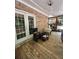 Covered porch and deck patio features classic French doors and wood floors at 6625 Starling Sw Pl, Mableton, GA 30126