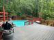 Backyard pool featuring an expansive deck, red railings and a barbecue grill at 6625 Starling Sw Pl, Mableton, GA 30126