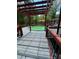 This backyard pool is surrounded by a wood deck with a red pergola at 6625 Starling Sw Pl, Mableton, GA 30126