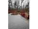 Grey deck with red railings surrounding an inground pool at 6625 Starling Sw Pl, Mableton, GA 30126